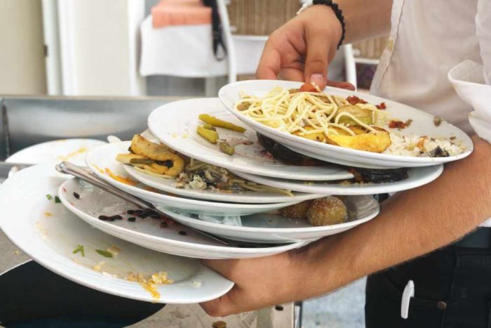 restaurant food waste on dirty plates
